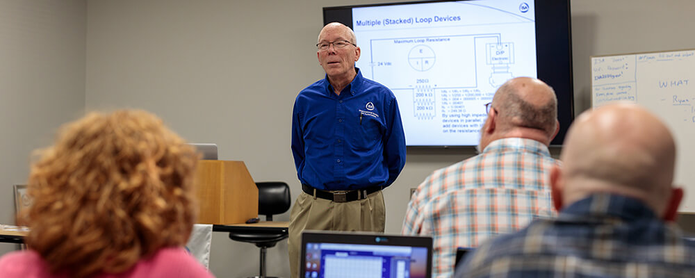 White-male-wearing-an-ISA-shirt-lecturing-to-students