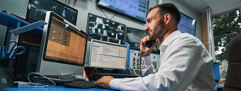 Man in a control room on phone